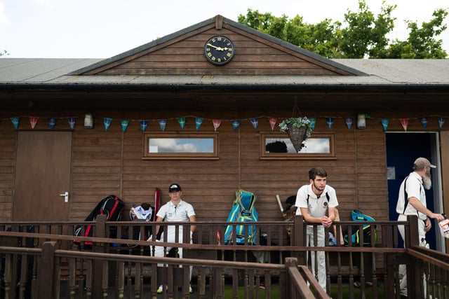Hambledon Cricket Club players look on as they return to action at Ridge Meadow. Pic: Jordan Pettitt/Solent News & Photo Agency