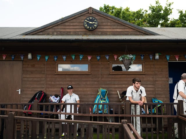 Hambledon Cricket Club players look on as they return to action at Ridge Meadow. Pic: Jordan Pettitt/Solent News & Photo Agency