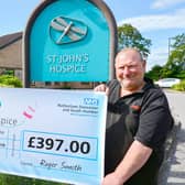 Julie and Roger are pictured handing over their cheque at St John’s