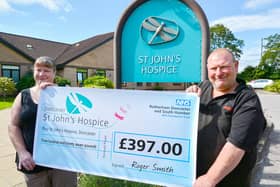Julie and Roger are pictured handing over their cheque at St John’s