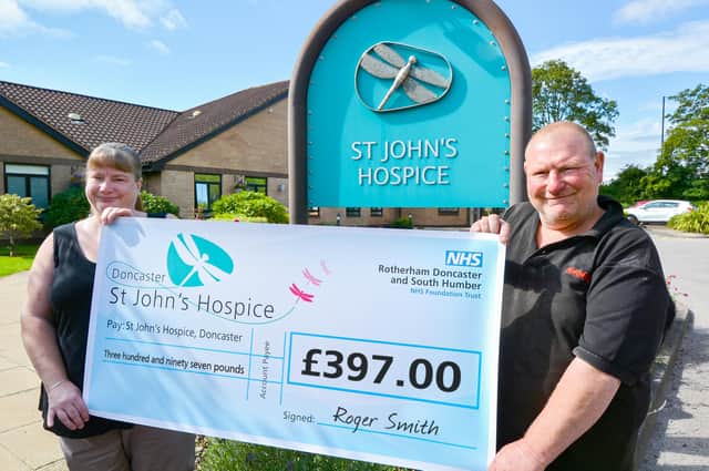Julie and Roger are pictured handing over their cheque at St John’s