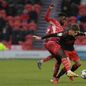Jordy Hiwula tussles with Fleetwood's Harrison Biggins. Picture: Howard Roe/AHPIX