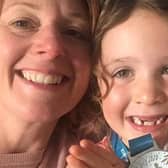 Rebecca Snape with her duaghter Grace who is holding the 100 mile medal.