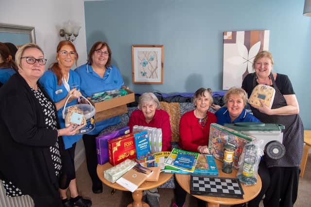 Staff and residents from Brailsford House Care Home receiving their care package from Barratt Homes.