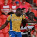 Doncaster Rovers defender Joseph Olowu challenges Mansfield Town's Lucas Akins for the ball.