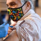A member of the public receive the Oxford/AstraZeneca Covid-19 vaccine at a temporary vaccination centre in St Columba's Church in Sheffield (Photo by OLI SCARFF/AFP via Getty Images)