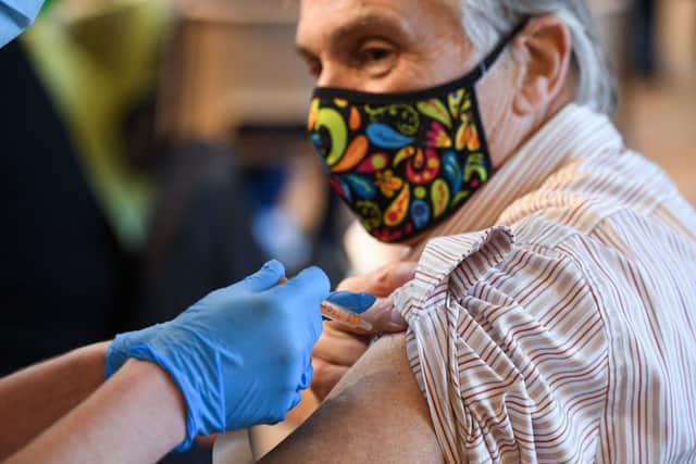 A member of the public receive the Oxford/AstraZeneca Covid-19 vaccine at a temporary vaccination centre in St Columba's Church in Sheffield (Photo by OLI SCARFF/AFP via Getty Images)