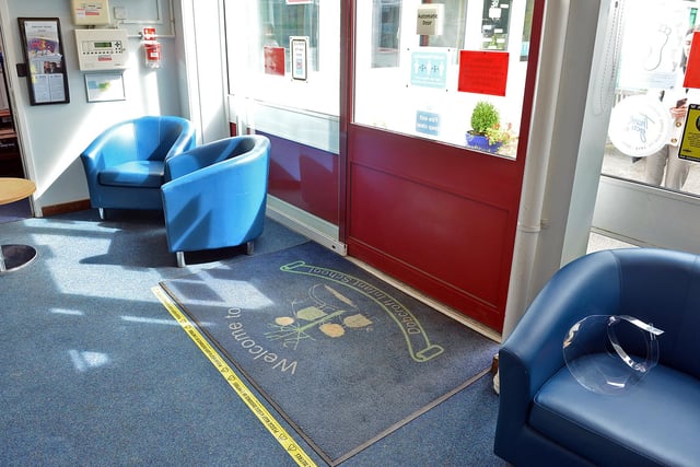 Tape on the floor signifies where visitors to the building should stand