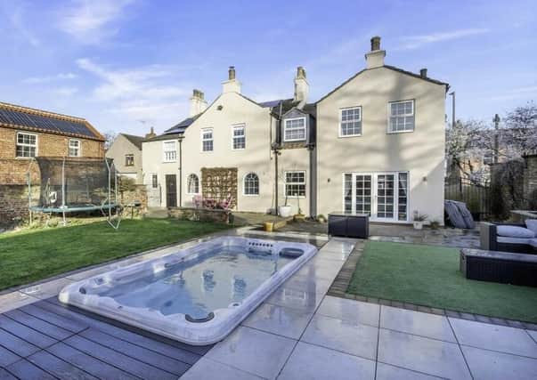 The impressive property has its own heated swim spa pool in the gardens.