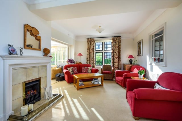 The drawing room has a coal effect gas fire and arched display recess.