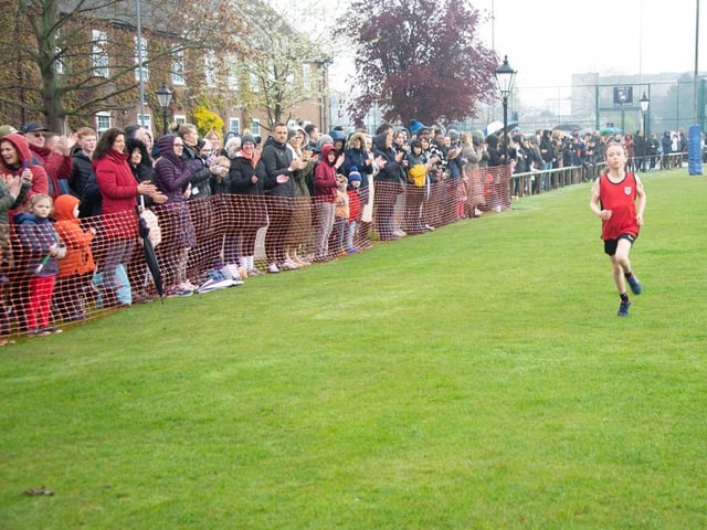 The first girl over the line in the U9s race.