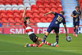 Doncaster Rovers' Liam Ravenhill tackles Port Vale's Oliver Arblaster during pre-season.