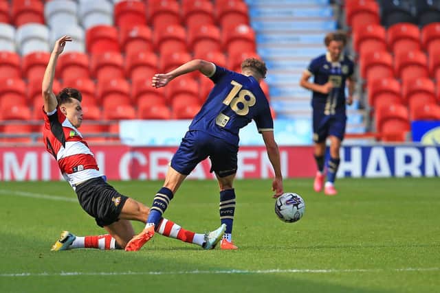 Doncaster Rovers' Liam Ravenhill tackles Port Vale's Oliver Arblaster during pre-season.