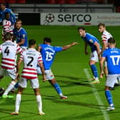 Doncaster's Tom Anderson has a shot a goal against Stockport County.