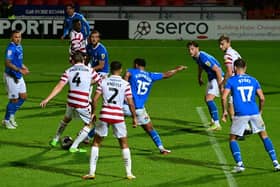 Doncaster's Tom Anderson has a shot a goal against Stockport County.