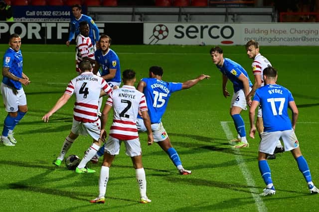 Doncaster's Tom Anderson has a shot a goal against Stockport County.