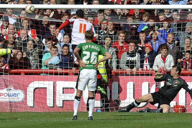 Brentford's Marcello Trotta smacks his penalty off the crossbar