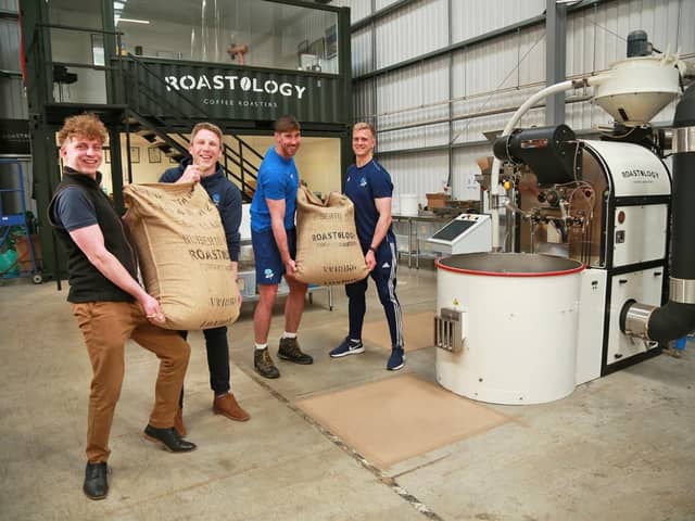 Cafeology's sustainability manager Liam Worsley, left, unloads the coffee he helped pick in Costa Rica with members of Sheffield RUFC, one of Cafeology's local customers