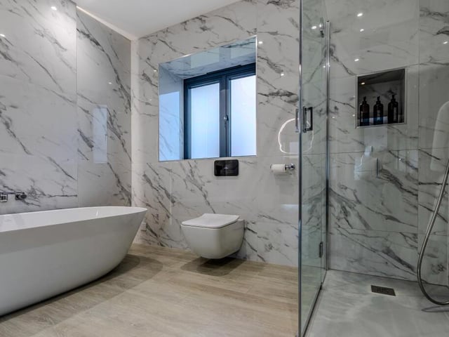 A stylish, modern bathroom with free standing bath and walk in shower.