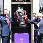 Bitter blow: Rugby League World Cup chief executive Jon Dutton with Prime Minister Boris Johnson and the men's trophy. Now the tournament is in doubt. Picture by Simon Wilkinson/SWpix.com