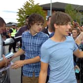 One Direction boy band member Louis Tomlinson meets fans outside the Trax FM studio in Doncaster.