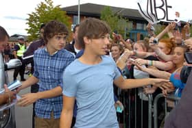 One Direction boy band member Louis Tomlinson meets fans outside the Trax FM studio in Doncaster.