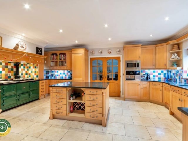 The spacious and bespoke fitted kitchen with central island.