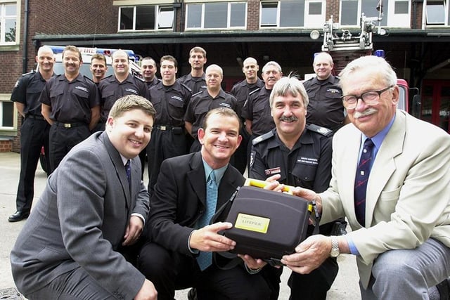 Karisma nightclub general manager Andy Clarkson (second left) and deputy manager Bryon Webster (left), hand over a defibrillator machine to senior divisional officer Brian Robjohns, watched by British Heart Foundation's Bawtry branch chairman, Frank Johnson (right), and firefighters at Doncaster Fire Station in Leger Way, Doncaster, July 2000