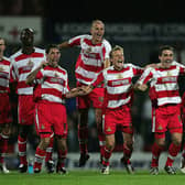 Doncaster's players celebrate their penalty shoot out victory against Manchester City. Photo by Michael Steele/Getty Images