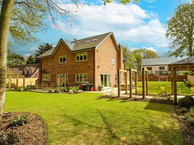 A view of the impressive house from its surrounding gardens.