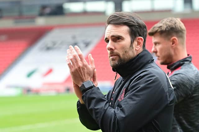 Doncaster boss Danny Schofield applauds fans following the club's final game of the season.