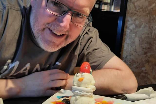 Free Press reporter Darren Burke with the Adorable Snowman at Creams Cafe in Doncaster.