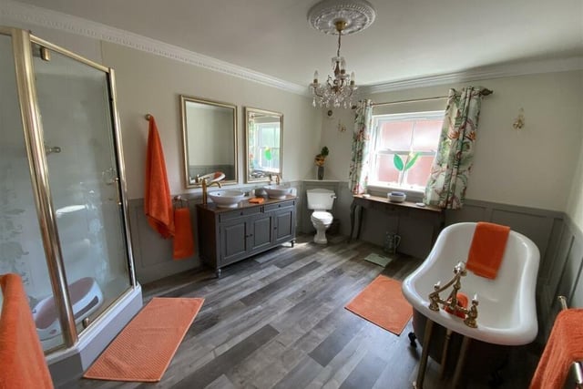 The family bathroom with a free standing bath, and twin vanity washbasins.