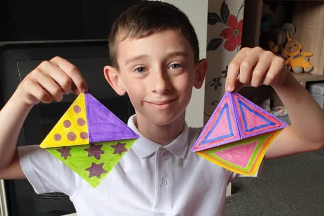 Charlie with bookmarks that he made.