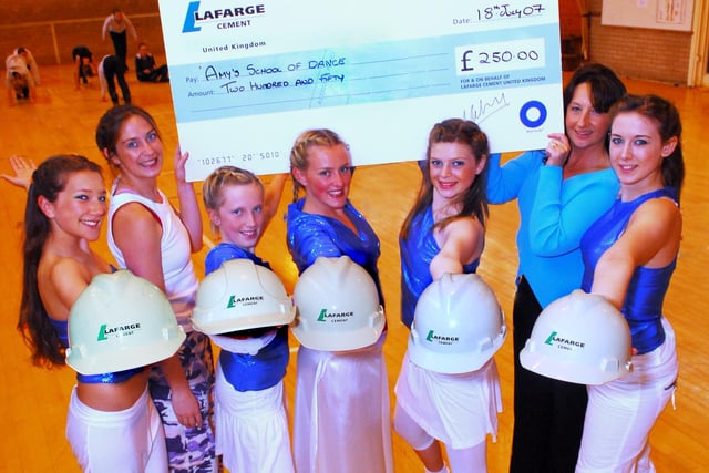Dancers from Hope Valley College's Street 3 class with their teacher Amy Fairfax, back left, receive a cheque from Lafarge Cement' representative Louise Saxon, back right.