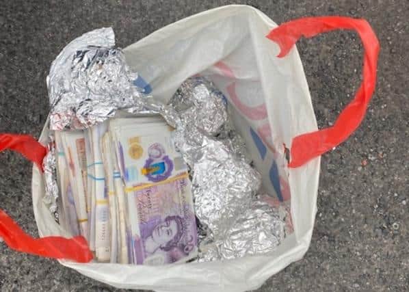 Some of the cash which was found by police on the back seat of a Chevrolet which was stopped on the M1 in South Yorkshire