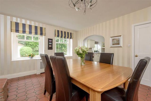 A nice, large dining room, with a stylish tiled floor in case of food and drink spillage.