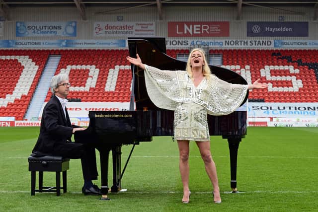 Rachael Wooding pictured performing on the pitch at the Keepmoat Stadium, with Pianist John G Smith. NDFP-27-04-21-LiveMusicReturn 1-NMSY