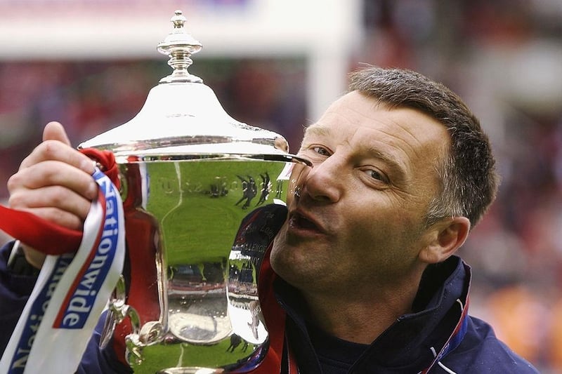 Doncaster Rovers manager Dave Penny gives the trophy a kiss as he celebrates victory and promotion after the Conference Promotion Final match between Dagenham & Redbridge and Doncaster Rovers held on May 10, 2003 at the Britannia Stadium.