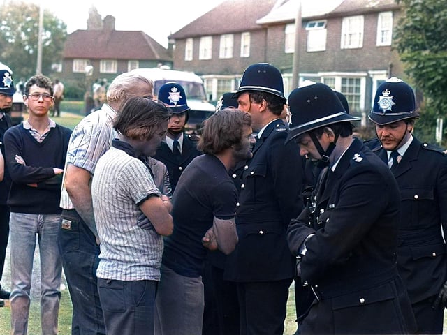 Police and striking miners exchange words in Doncaster.
