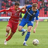 Kyle Knoyle tussles with Gillingham's Conor Masterson. Picture: Andrew Roe/AHPIX LTD