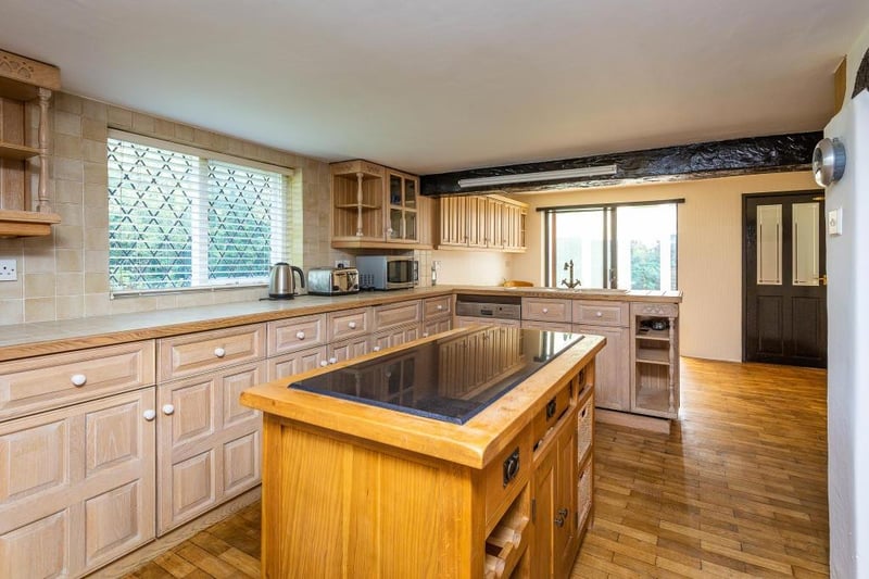 A spacious breakfast kitchen has a central island.