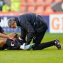 Doncaster's Fejiri Okenabirhie receives attention from the physio in his last game for Rovers against Blackpool in May 2021.