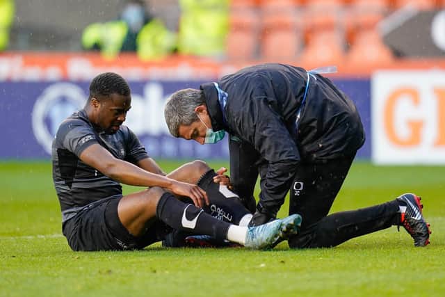 Doncaster's Fejiri Okenabirhie receives attention from the physio in his last game for Rovers against Blackpool in May 2021.