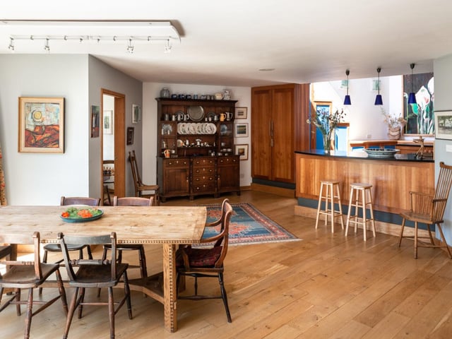 The ground floor comprises a series of interconnected living and dining rooms. The kitchen feels "open and sociable", with bespoke cabinetry and free-standing worktops.