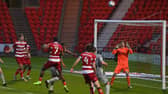 Omar Bogle sees a header fly over the bar against Burton Albion. Picture: Andrew Roe/AHPIX