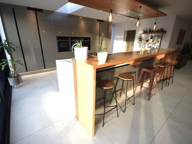 The well equipped kitchen has a breakfast bar for five.