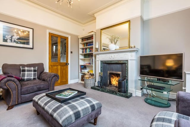 The lounge is made cosy by a fire within this stunning feature fireplace.