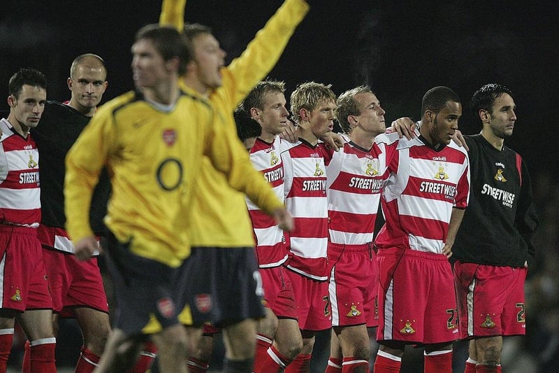 Arsenal celebrate as the Doncaster team look on during a penalty shoot-out in the Carling Cup Quarter Final on December 21, 2005. Arsenal won the shoot-out 3-1 after a 2-2 draw.