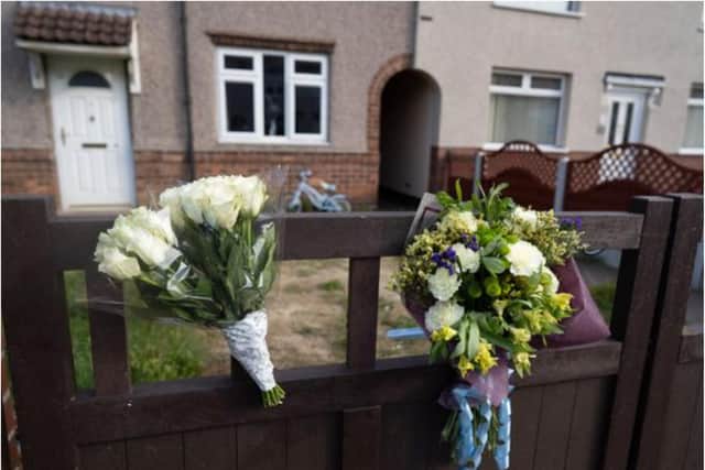 Floral tributes have been left at the scene in Woodlands. (Photo: SWNS).